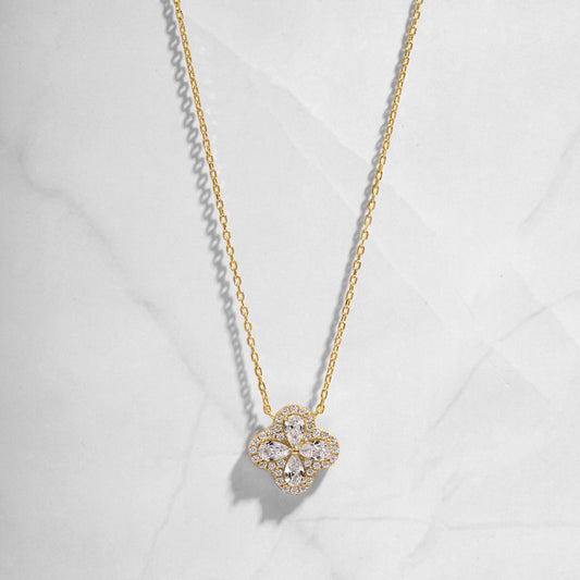 Close-up of four leaf clover pendant inspired by Van Cleef, highlighting intricate diamond details of pear shaped stones made of cubic zirconia.