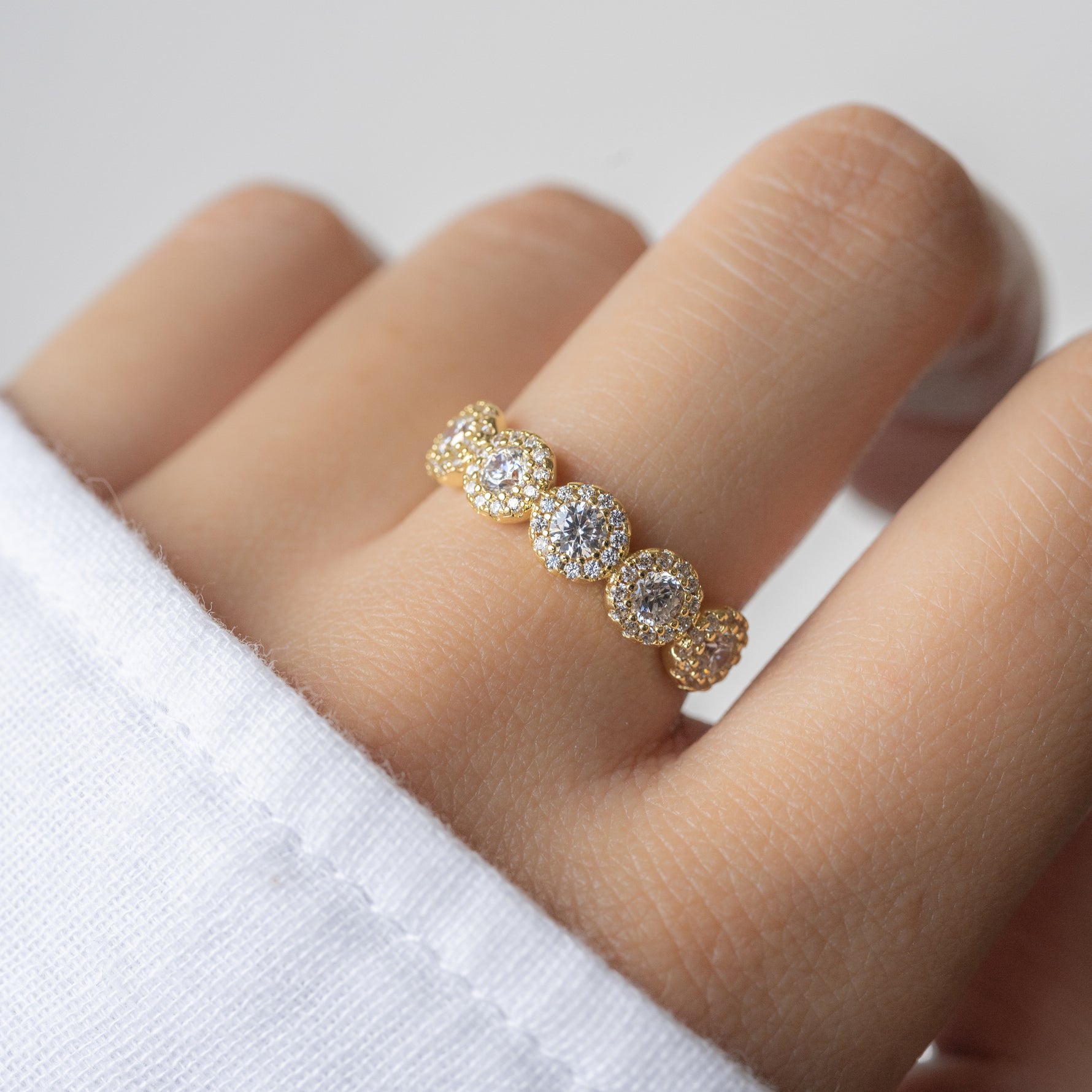 model wearing a cz ring with 5 stones and a halo