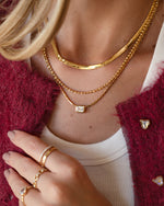 White CZ baguette bezel statement necklace by Sami Jewels, featuring bold gold chain and sparkling cubic zirconia accents.