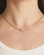 White CZ baguette bezel statement necklace by Sami Jewels, featuring bold gold chain and sparkling rectangular stones.