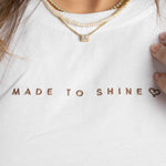 model wearing white "Made To Shine" tshirt