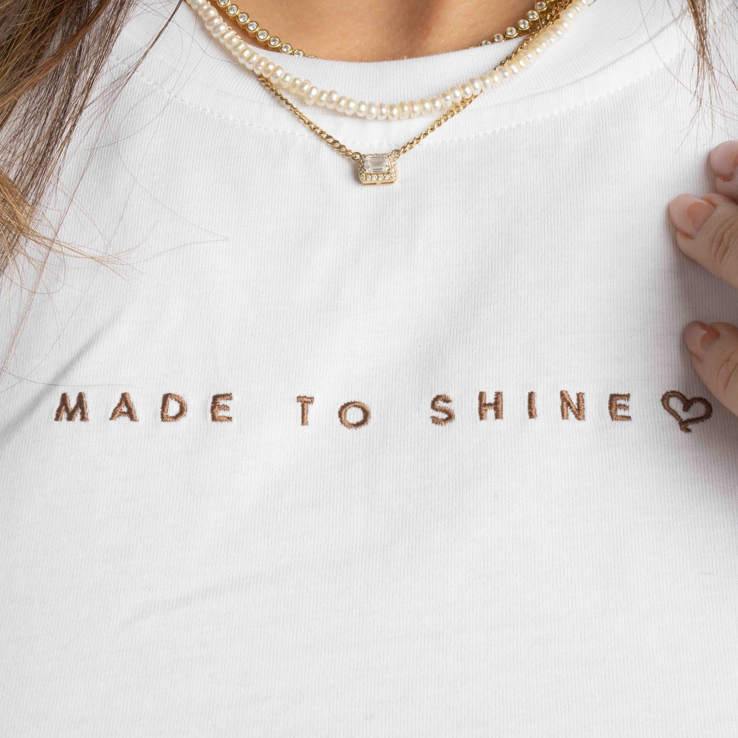 model wearing white "Made To Shine" tshirt
