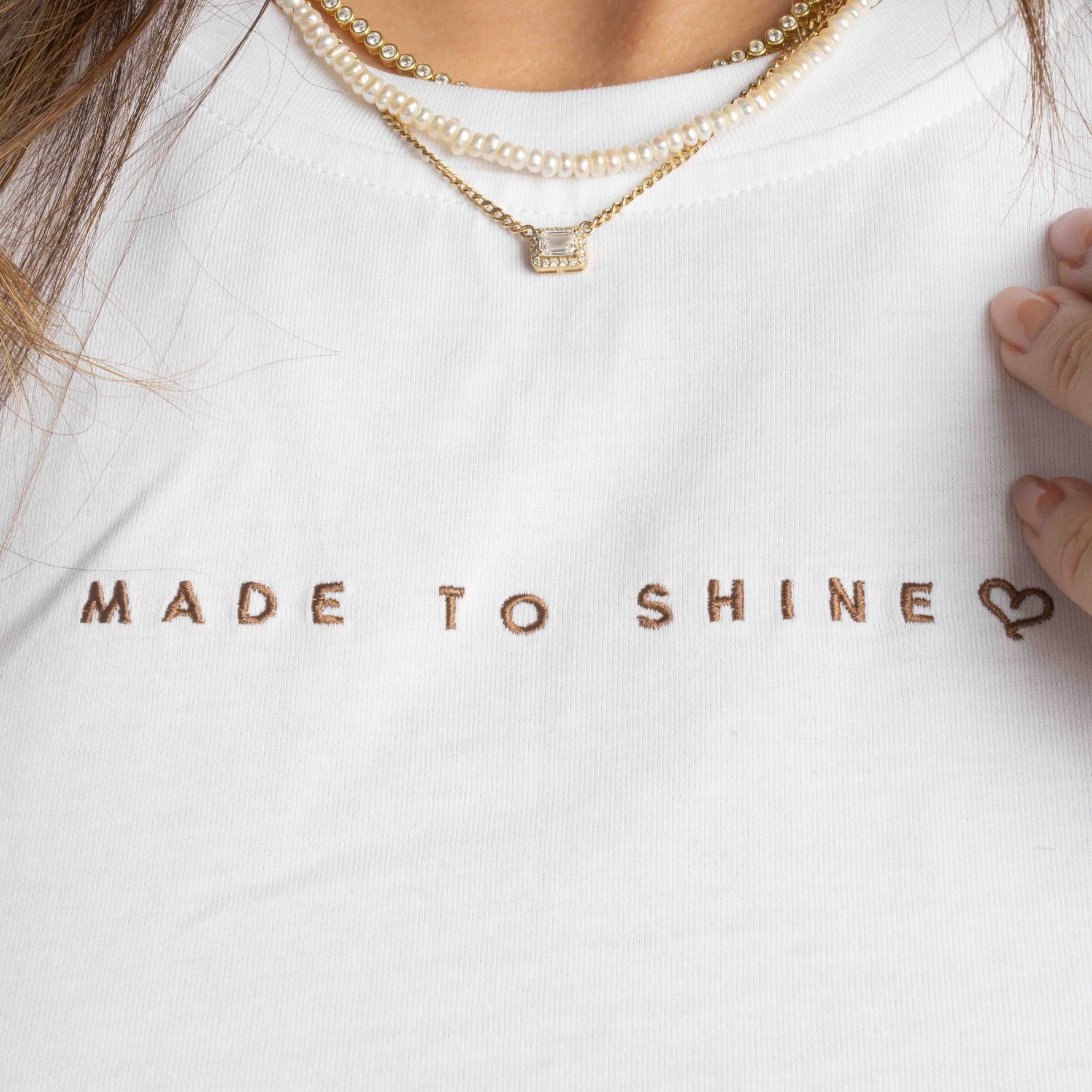 model wearing white "Made To Shine" tshirt