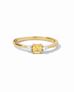 Yellow citrine cushion ring by Sami Jewels featuring a gold band on a white background.