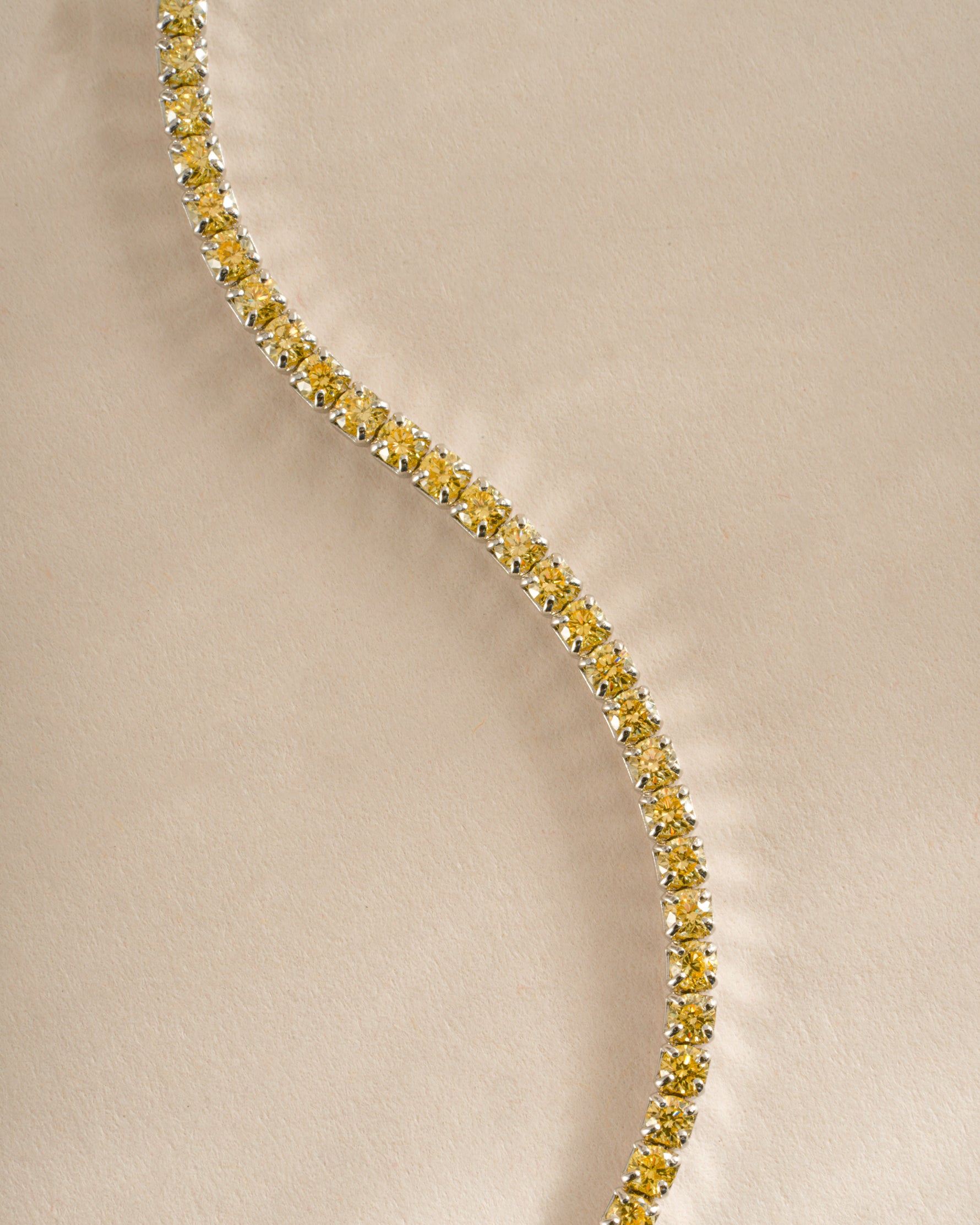 Close-up of Sami Jewels yellow diamond tennis anklet showcasing sparkling yellow diamonds on a delicate anklet chain.