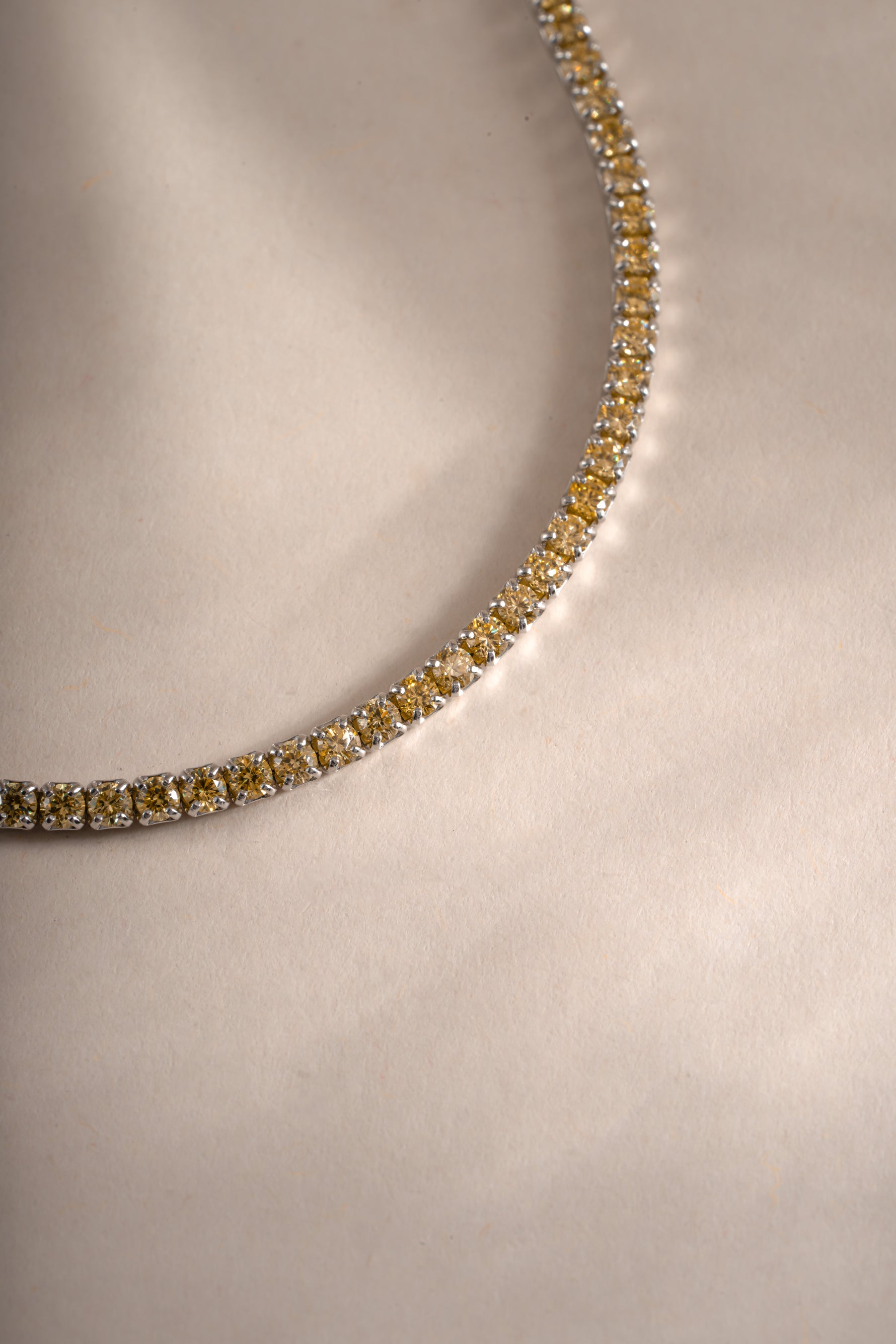 Close-up of Sami Jewels yellow diamond tennis bracelet featuring sterling silver links and sparkling yellow diamonds.