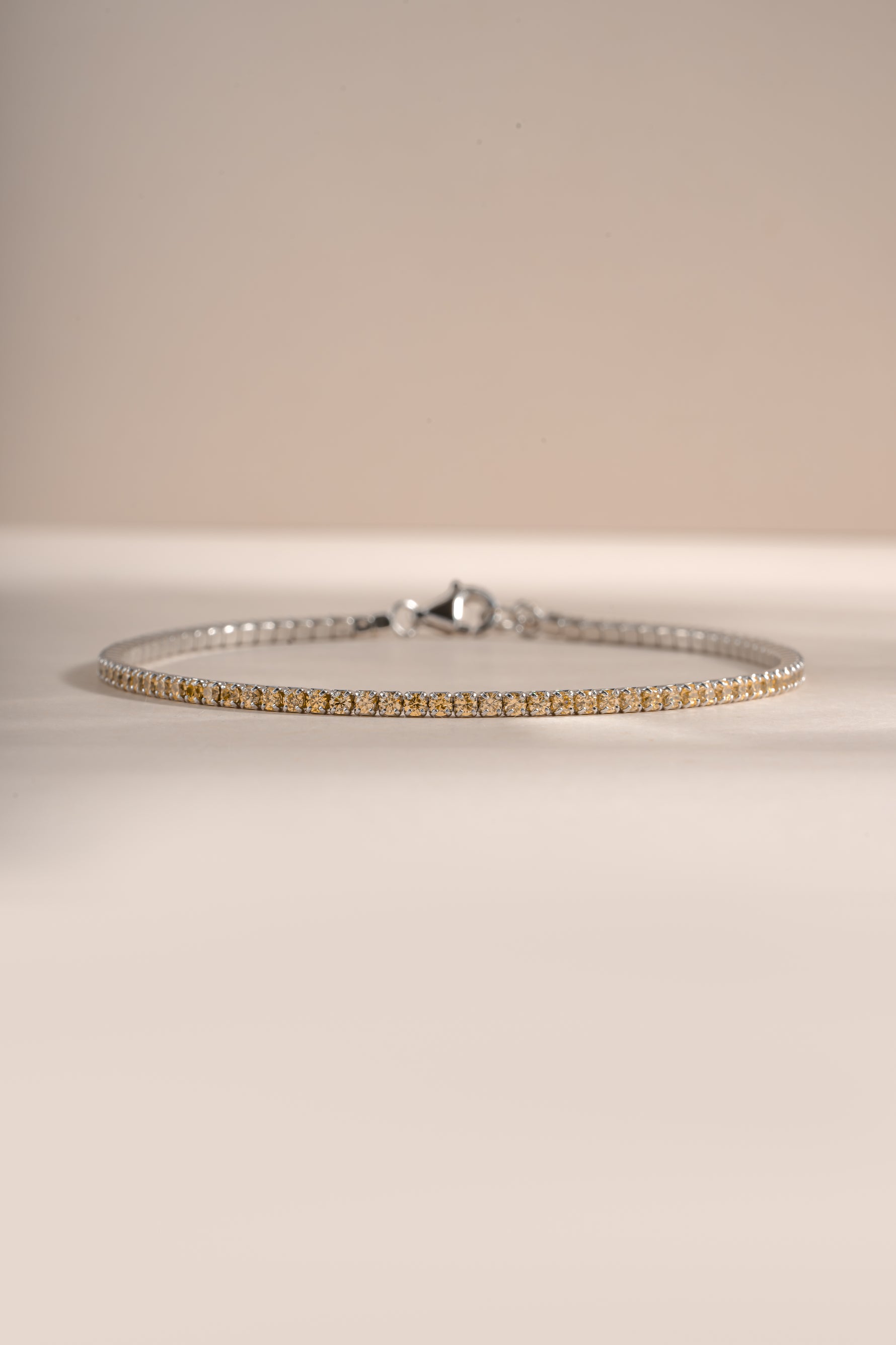 Yellow diamond tennis bracelet by Sami Jewels featuring sterling silver setting, front view showcasing sparkling stones and elegant design.