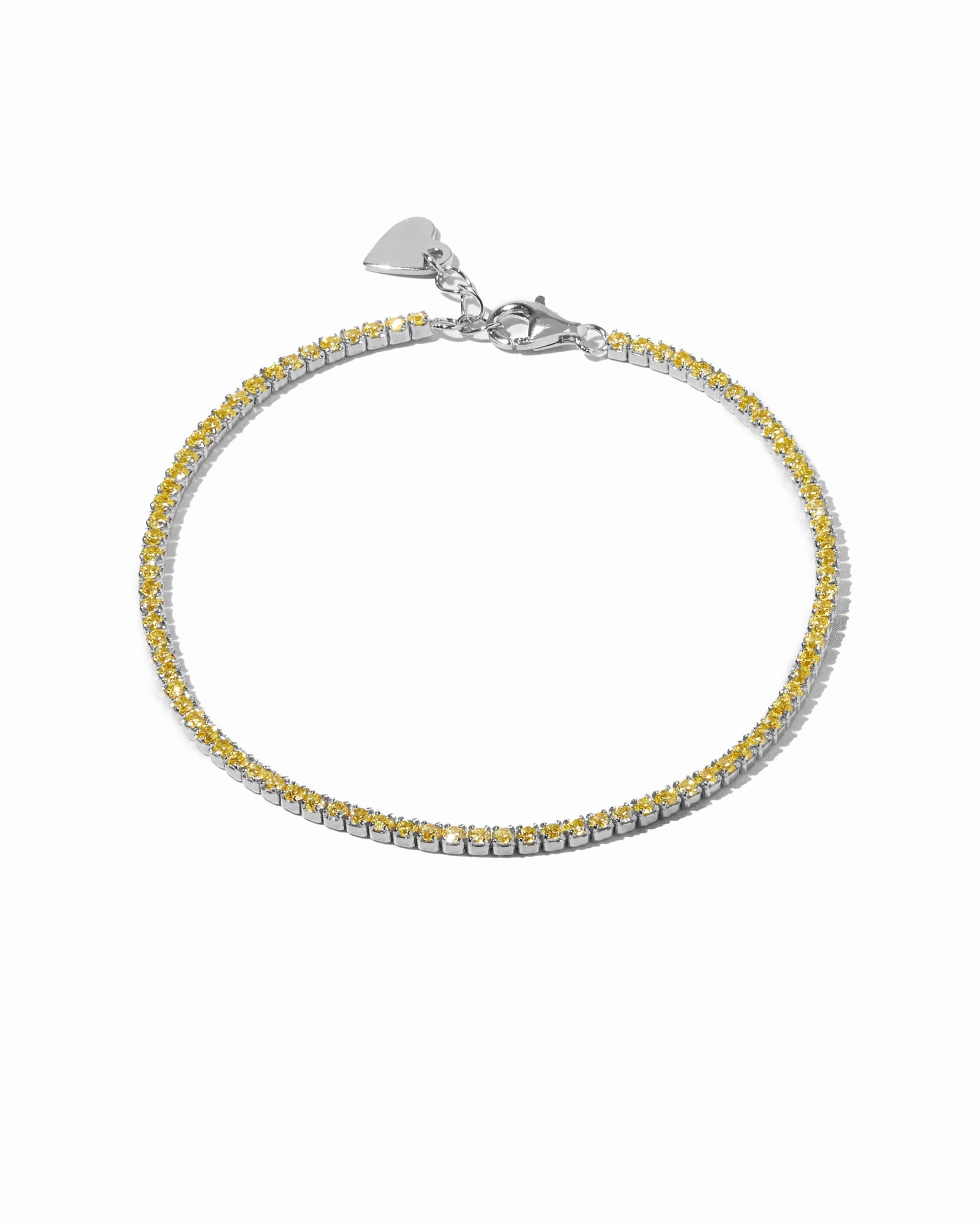 Yellow diamond tennis bracelet by Sami Jewels with sterling silver setting, displayed on a white background.
