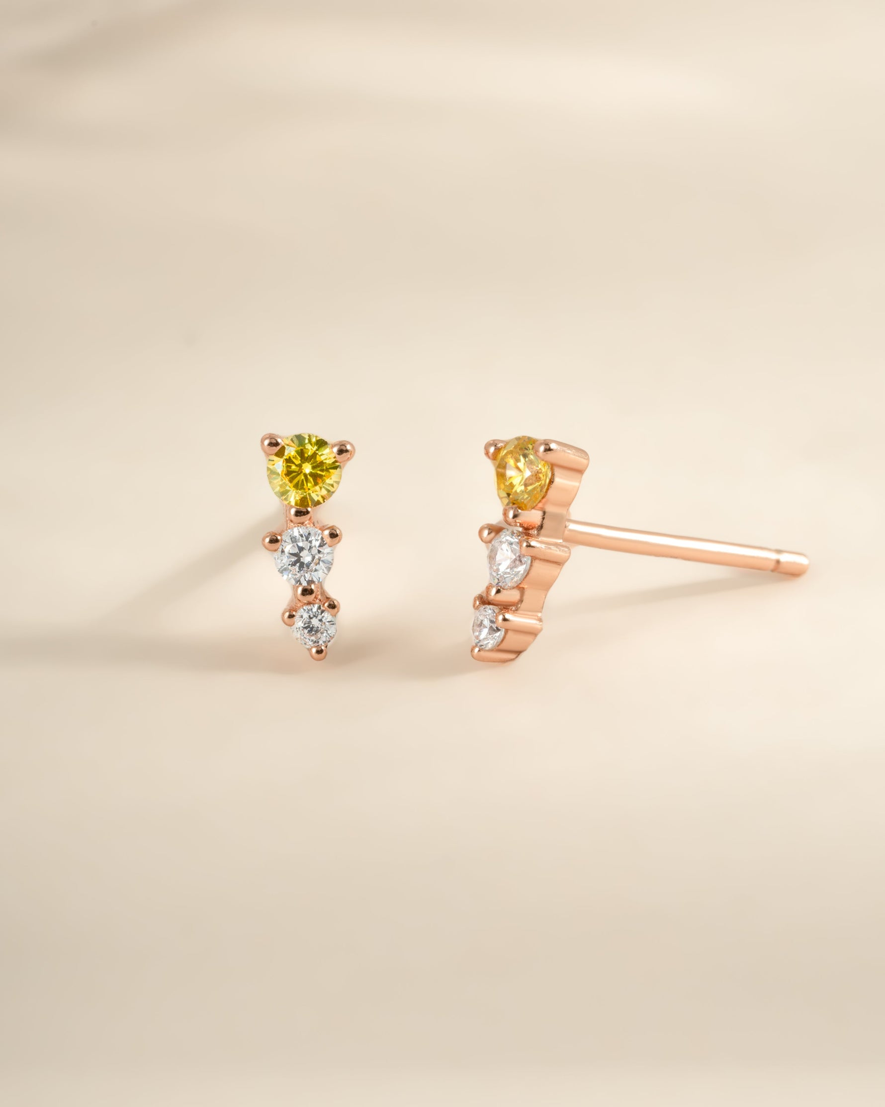 Yellow and diamond ear climber earrings in rose gold by Sami Jewels, featuring a sleek, curved design for elegant ear embellishment.