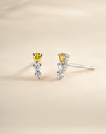 Yellow and diamond ear climber earrings by Sami Jewels in sterling silver, featuring a sleek, curved design with sparkling accents.