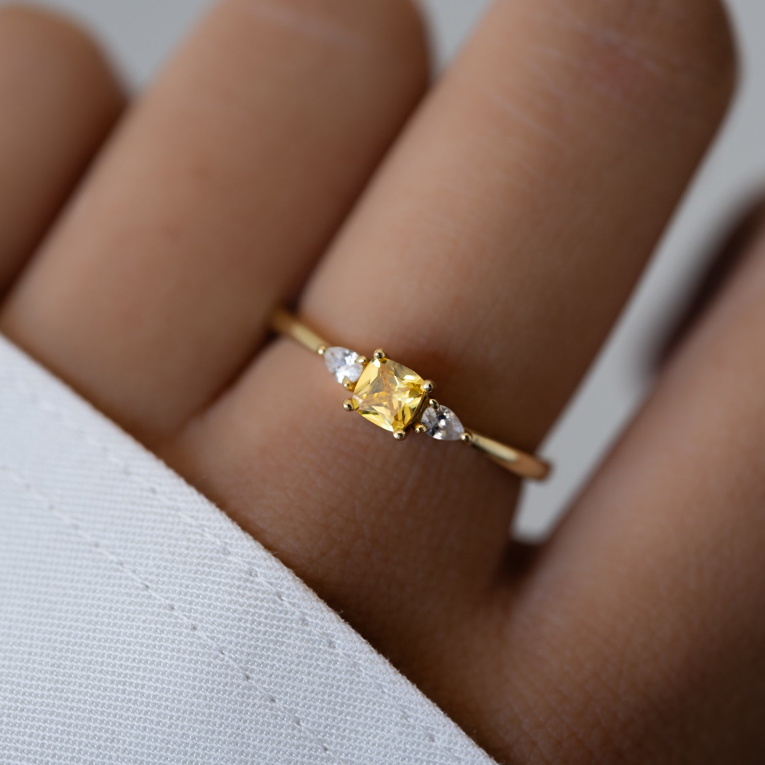 gold cushion ring with yellow gemstone