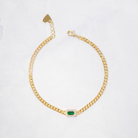 gold curb chain bracelet with emerald and diamond charm