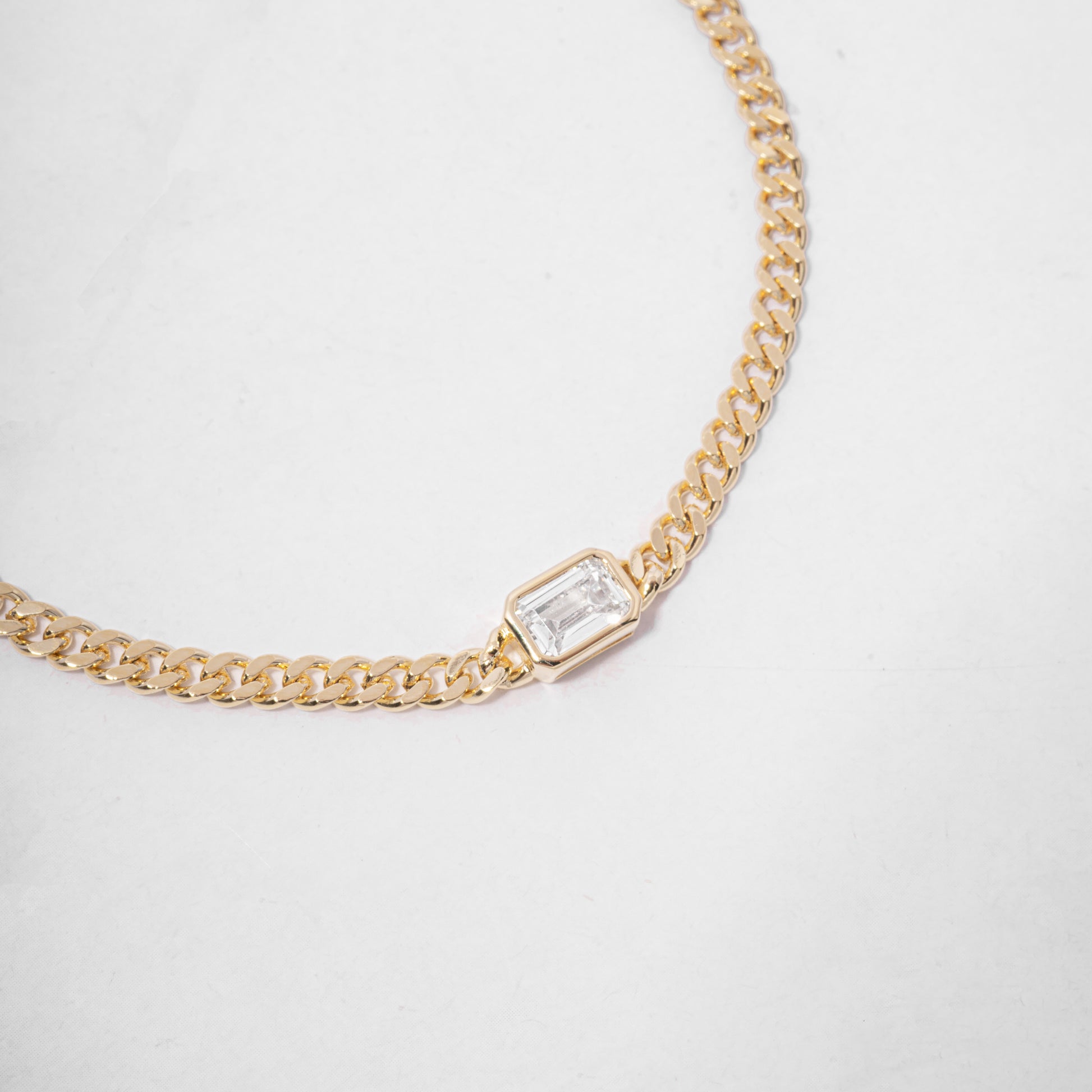 gold curb chain bracelet with diamond bezel baguette charm