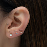 Multiple sizes of diamond cz stud earrings shown on models ear, 4mm, 3mm and 2mm sizes