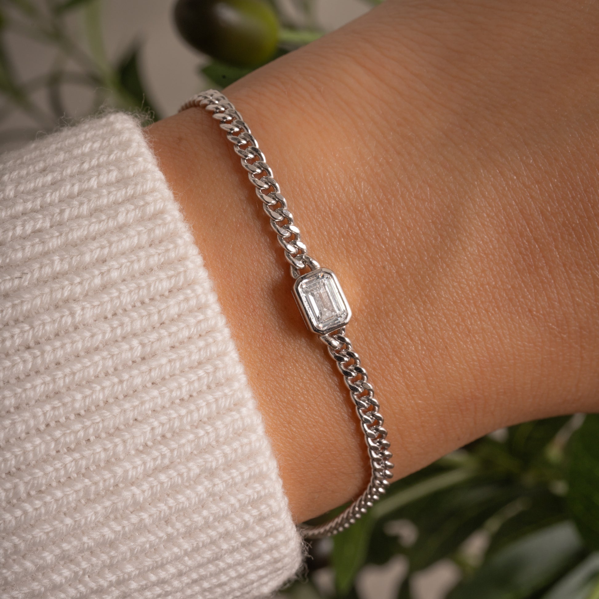 model wearing silver curb chain bracelet with diamond bezel baguette charm