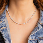 a close up of a woman wearing a necklace