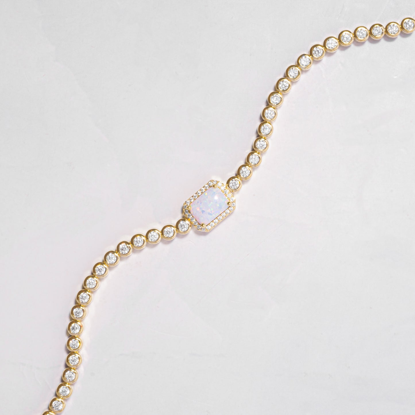 opal halo baguette charm on minimalist gold tennis bracelet