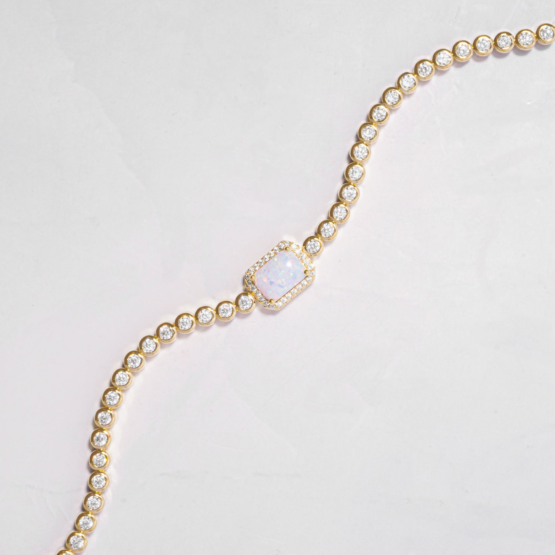 opal halo baguette charm on minimalist gold tennis bracelet