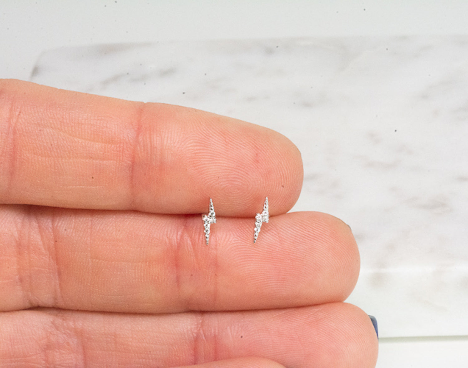 CZ studded silver lightning bolt earrings. 