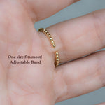 Model wearing ring with adjustable band. 