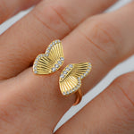 Upclose shot of gold adjustable butterfly ring. 