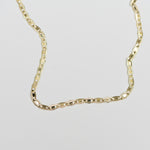 Up close image of gold chain anklet