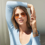 Model wearing aquamarine flower necklace.