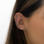 Model wearing trendy gold aquamarine and turquoise earring stack.
