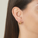 Model wearing delicate gold basket huggie earrings for a simple minimalist jewelry look.