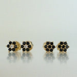Black onyx flower stud earrings with a white diamond center and in solid black.