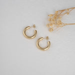 Bold gold chunky hoop earrings.