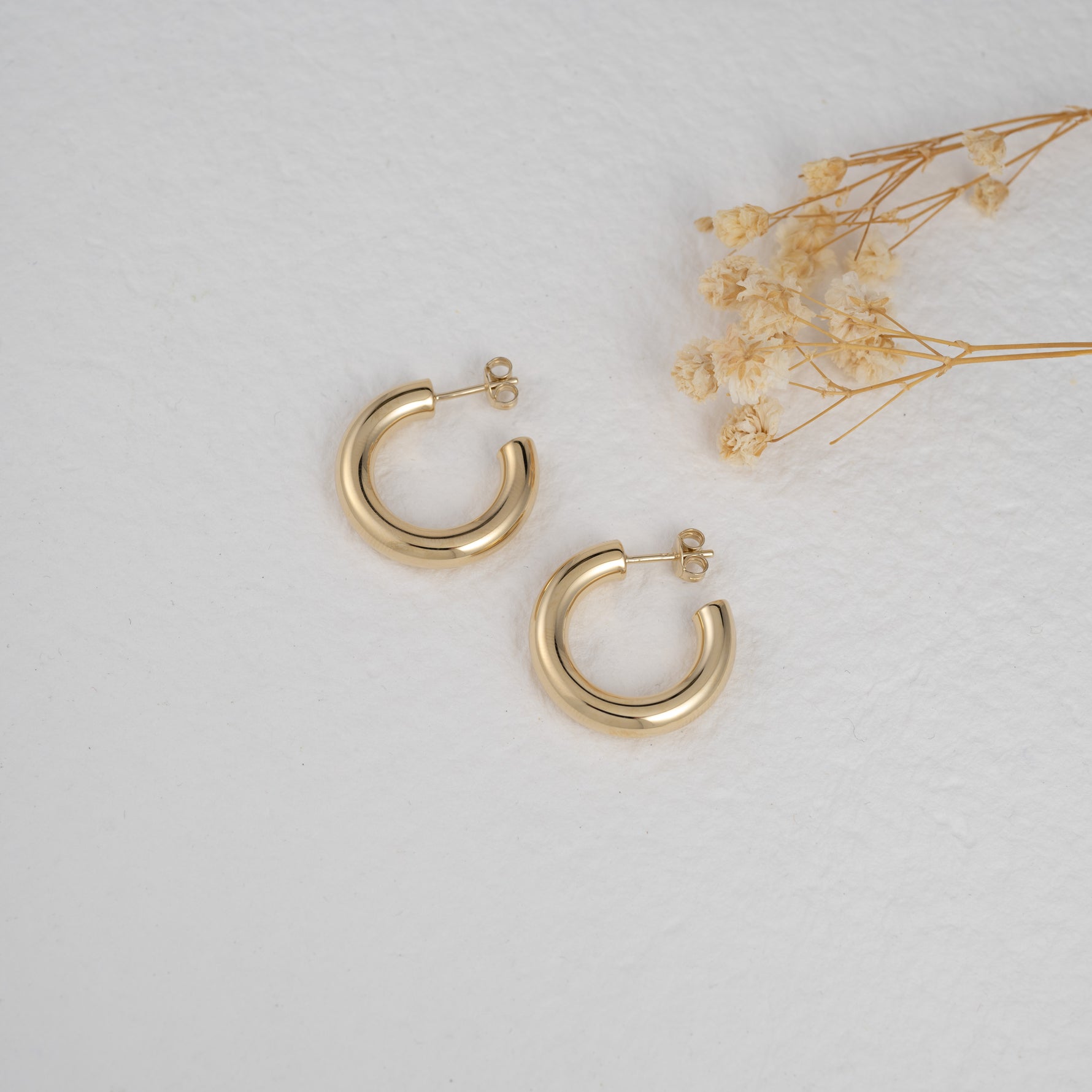 Bold gold chunky hoop earrings.