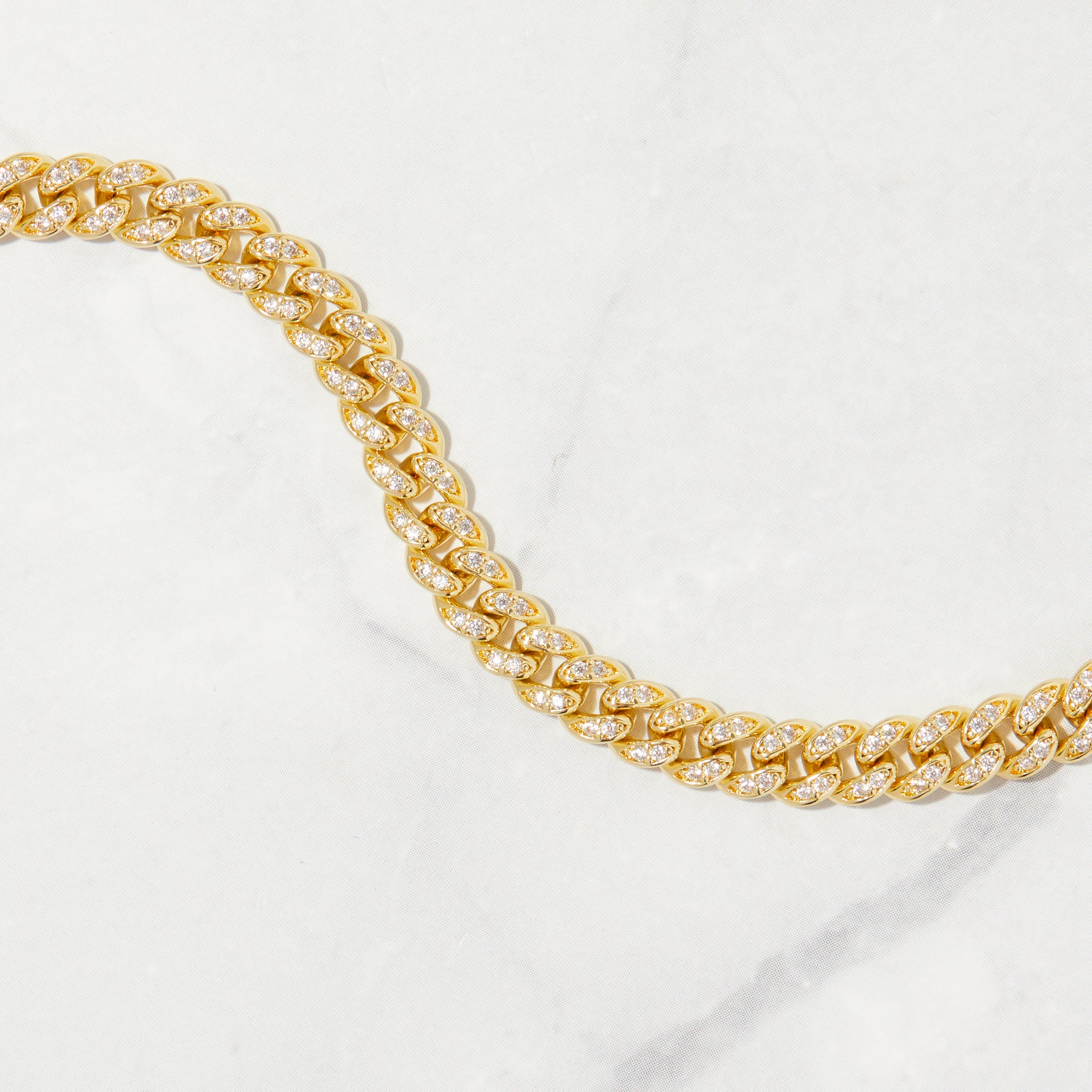 Up close image of diamond pave cz cuban link ankle bracelet in gold