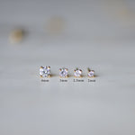 Gold stud earrings in multiple different sizes. 