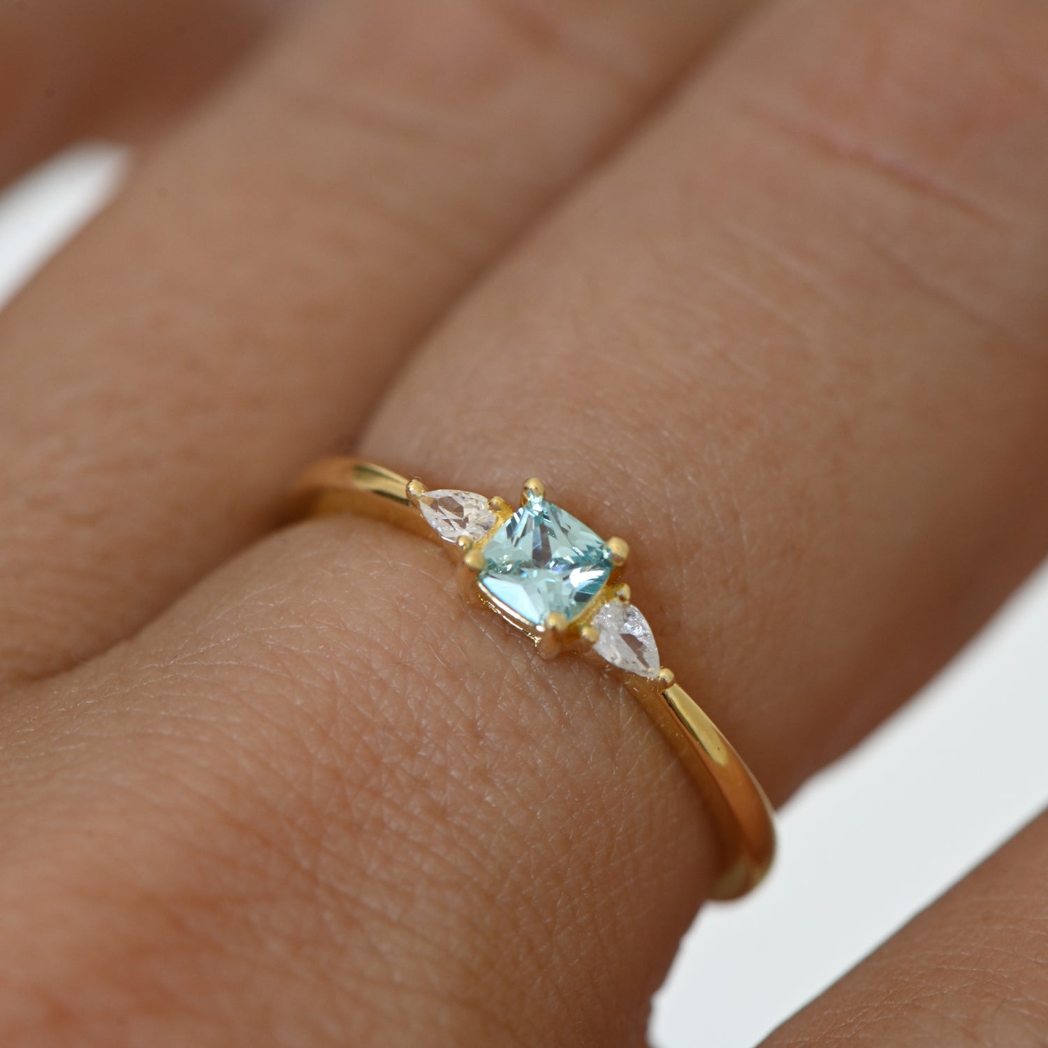 Model wearing aquamarine gemstone ring. 