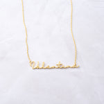 Gold custom script necklace on marble background