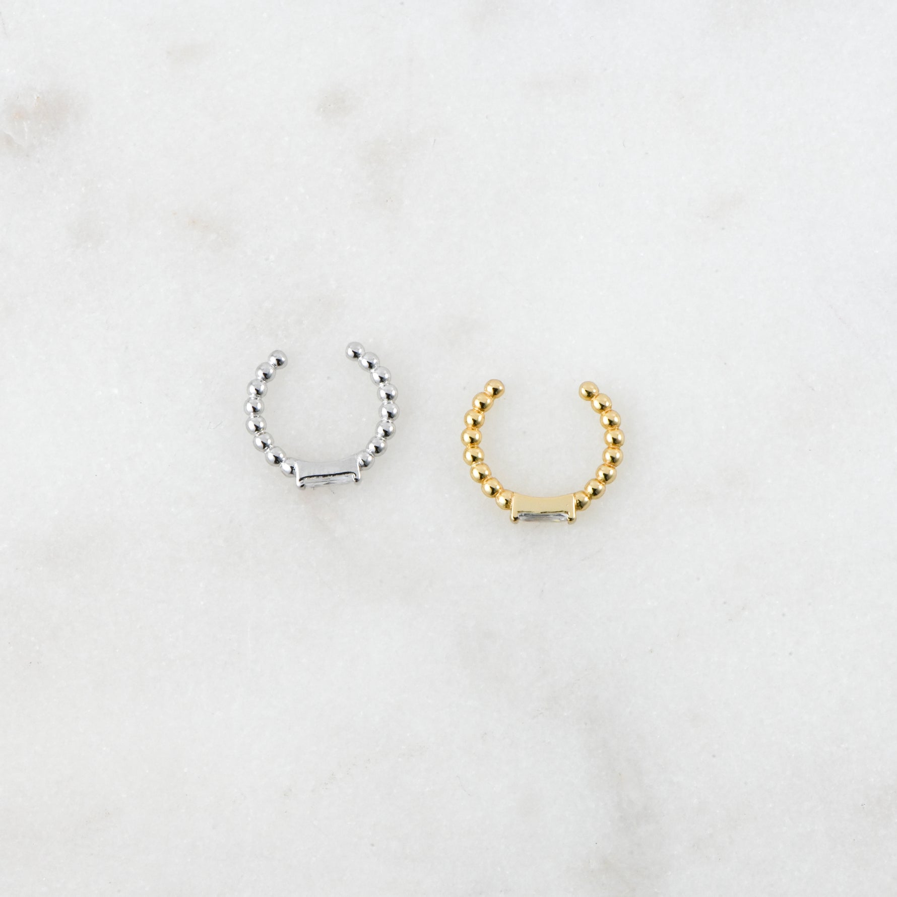 Dainty gold and silver beaded adjustable ear cuffs with baguette cz stones on them.