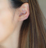Model wearing statement cz gold long ear climber.