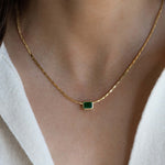 Model wearing emerald baguette bezel pendant statement necklace.
