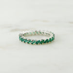 Sterling silver emerald slanted baguette ring in soft studio lighting. 