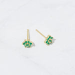 Emerald flower stud earrings from the above angle with gold post. 