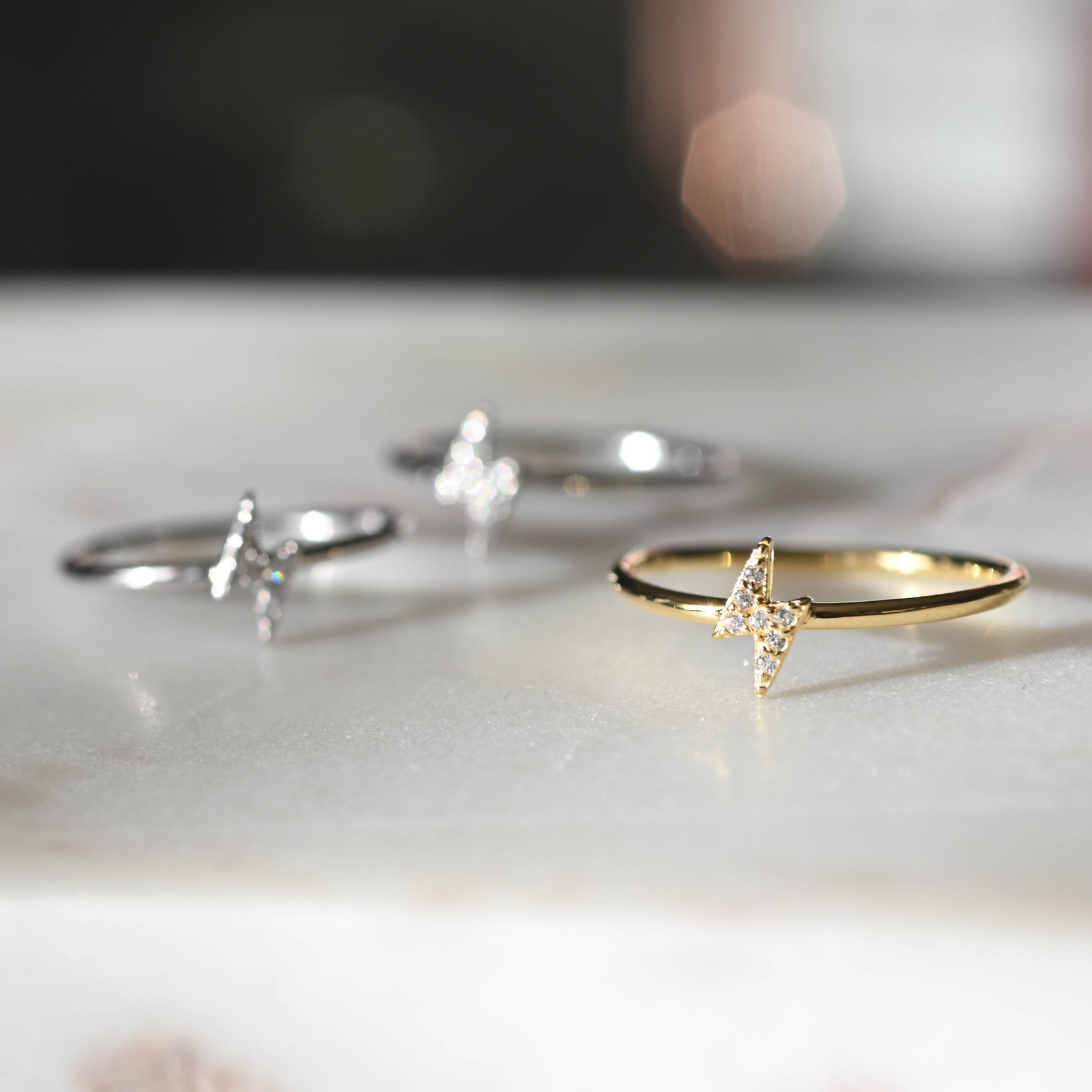 Lightning cz charm rings in gold and silver.