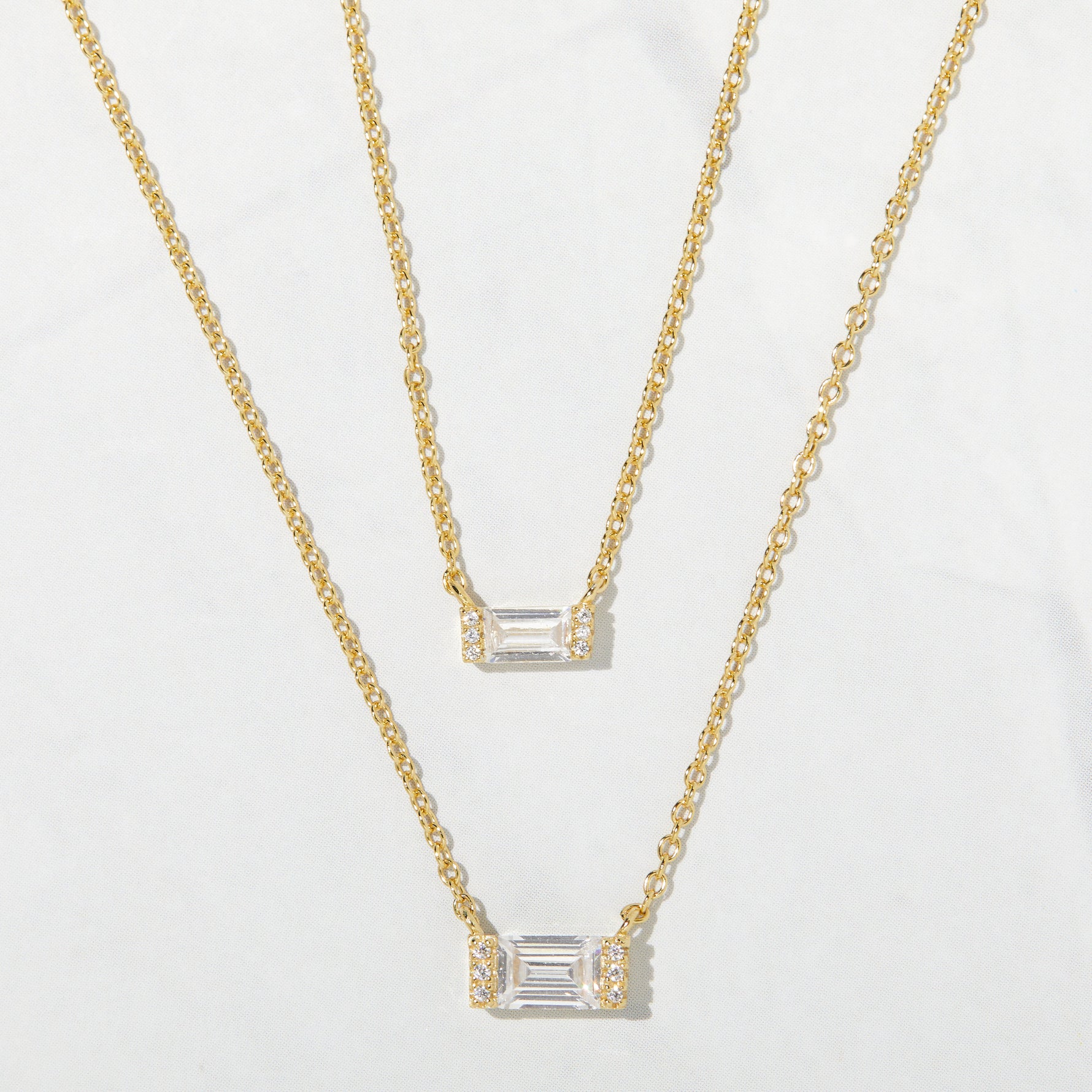 Simple gold baguette pendant necklaces in a small and a medium size. 