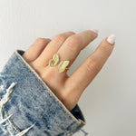 Model wearing statement gold butterfly ring. 