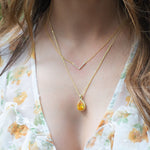 Model wearing delicate gold chevron necklace.