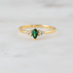Upclose shot of emerald marquise gemstone ring. 