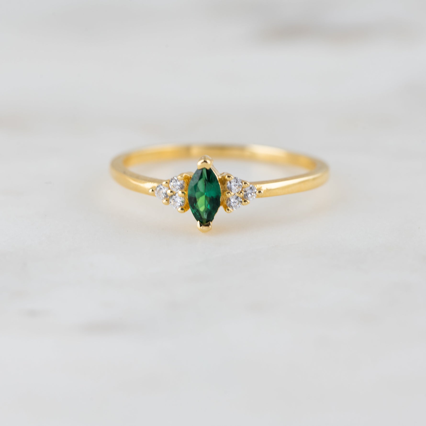 Upclose shot of emerald marquise gemstone ring. 