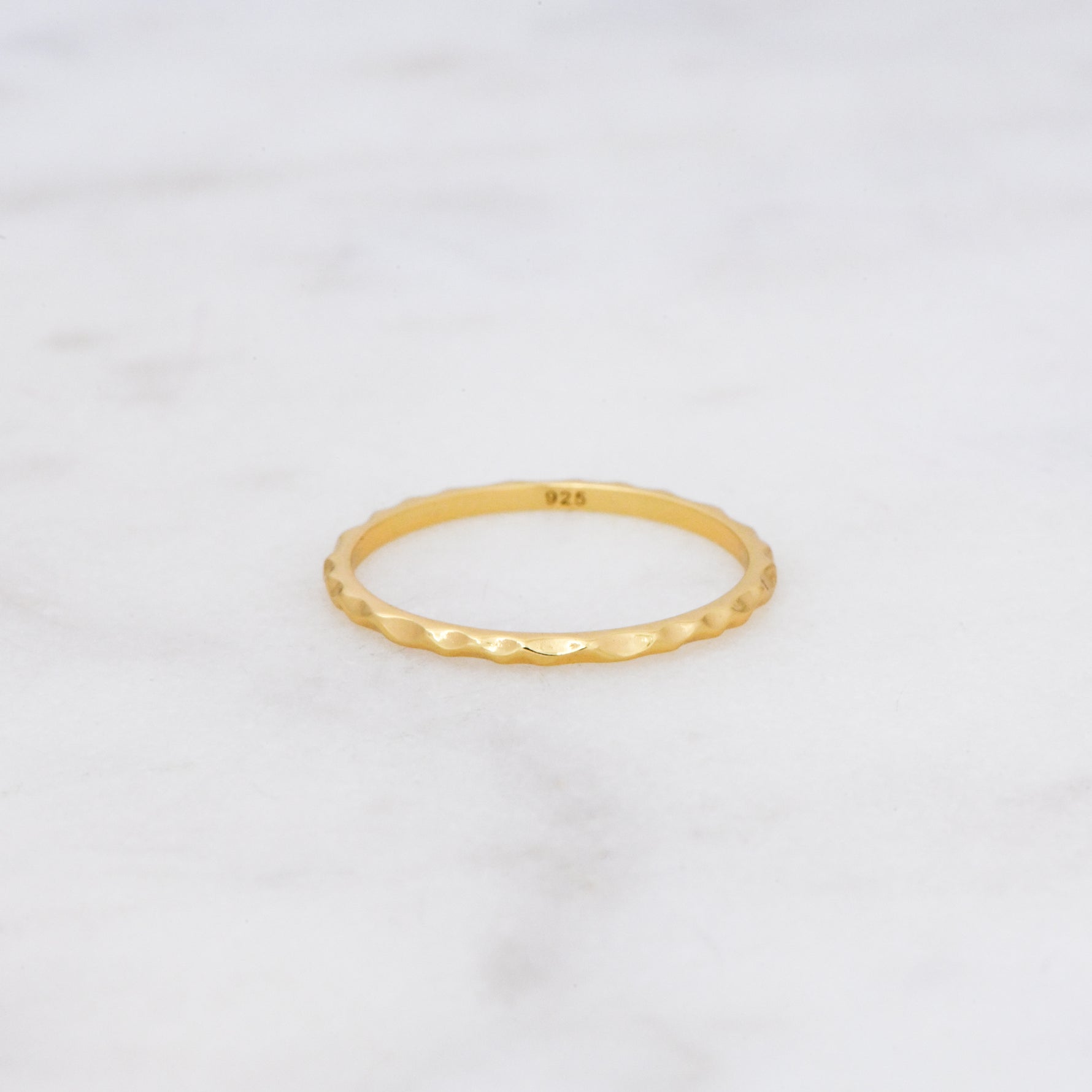 Upclose shot of 925 sterling silver 14k gold plated hammered textured ring.