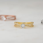 Upclose image of gold diamond double shank solitaire ring. 