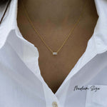 Model wearing medium size baguette pendant necklace with gold chain. 